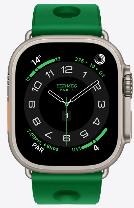Apple Watch Hermès Ultra 4, Circulaire analog watch face, (hour, minute and second hands, complications: Weather, Activity rings, Paris time and UV index), titanium case, natural colour, right side exterior, Digital Crown, raised side button, paired with Scub'H Diving band, Vert Vertigo colour (bright green), moulded rubber material, circular cut-outs centred