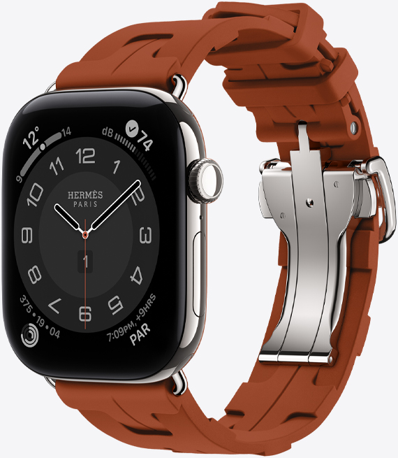 Apple Watch Hermès Series 12, Circulaire analogue watch face, (hour, minute and second hands, complications: Weather, Noise, Activity rings and Paris time), titanium case, silver colour, right side exterior, Digital Crown, side button, paired with Kilim Single Tour band, cuivre colour (brown), moulded rubber material, geometric interlocking design, silver-coloured metal clasp