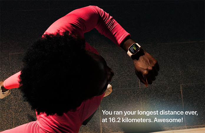 Photo of a man using his Apple Watch to track his run