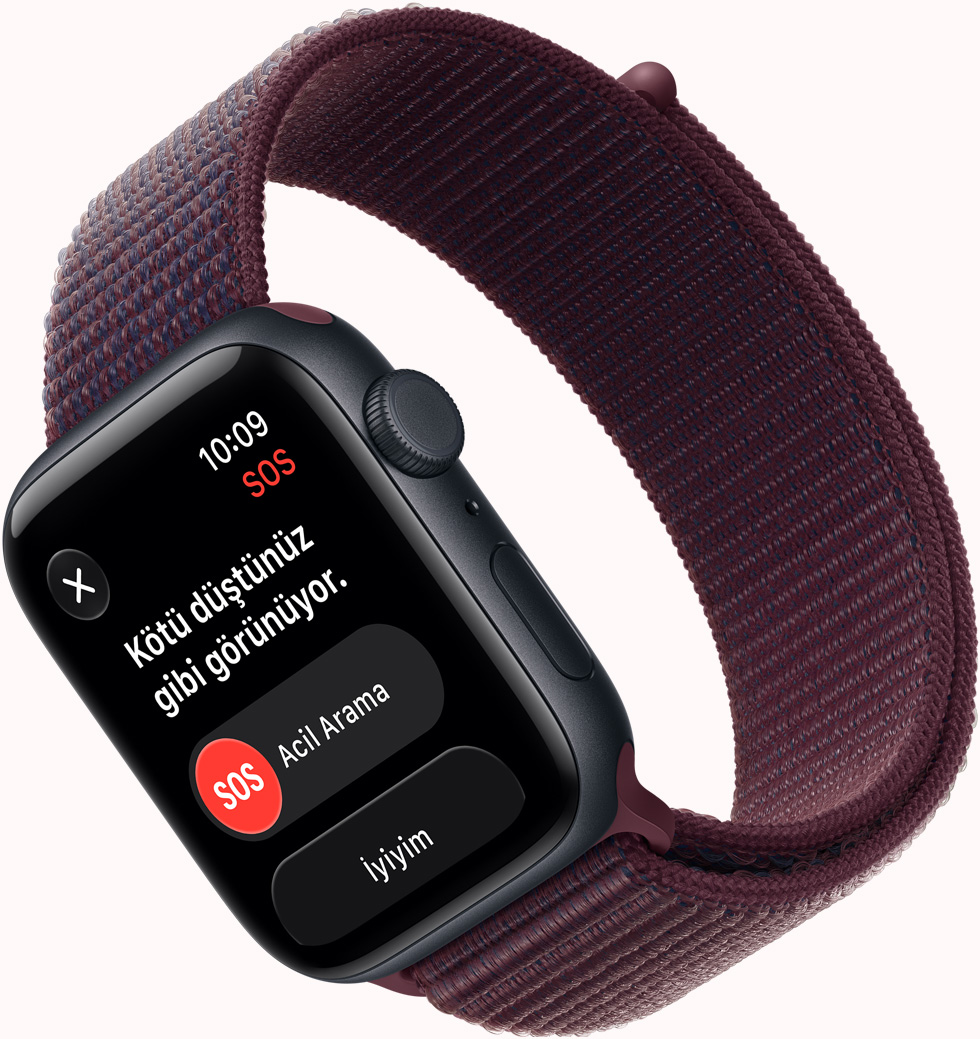 Apple Watch SE 3, ekranda SOS Düşme Algılama bildirimi gösteriliyor, Acil Arama düğmesi, alüminyum kasa, gece yarısı renk, Spor Loop kordon takılı, burgonya renk