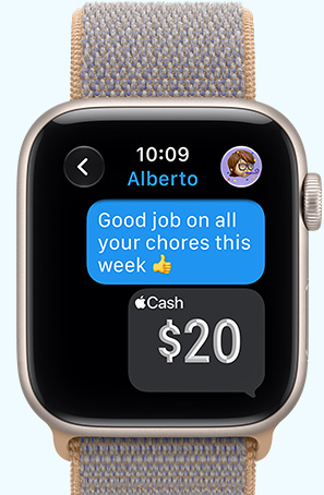 Apple Watch SE 3, screen shows 20 dollars in Apple Cash sent in Messages app, aluminum case, starlight color, connected to Sport Loop, chambray blue color (light blue-gray)