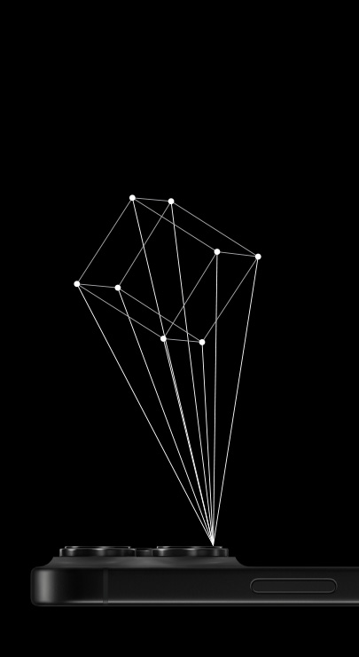 En iPhone ligger med forsiden ned, med omridset af en 3D-terning, der bliver projekteret fra en iPhones LiDAR-scanner